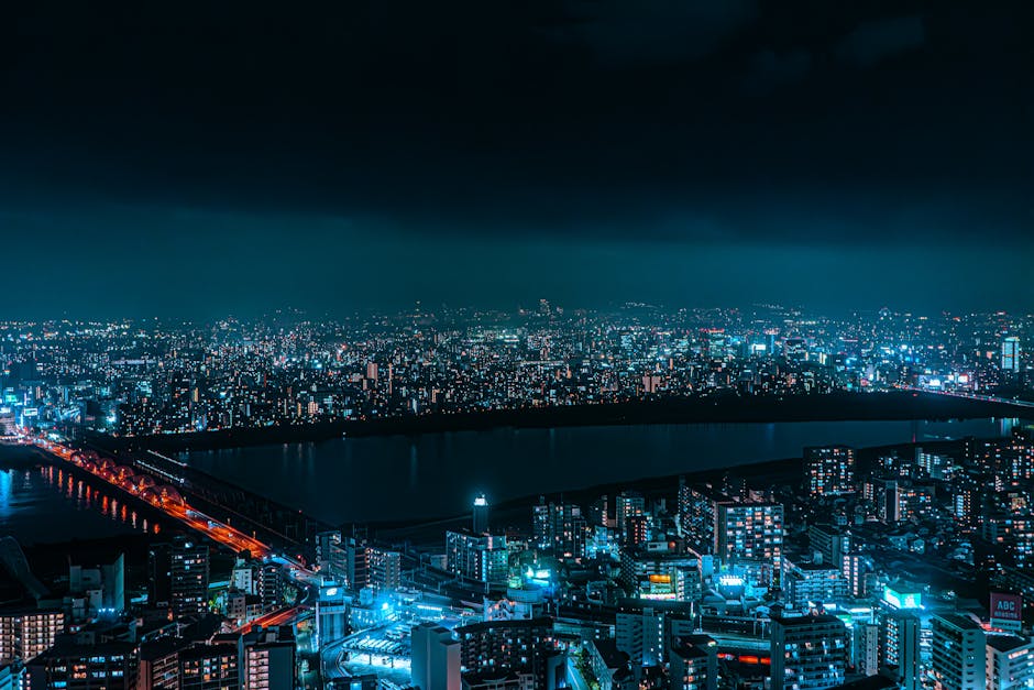 Captivating nighttime urban cityscape with illuminated buildings and river view.