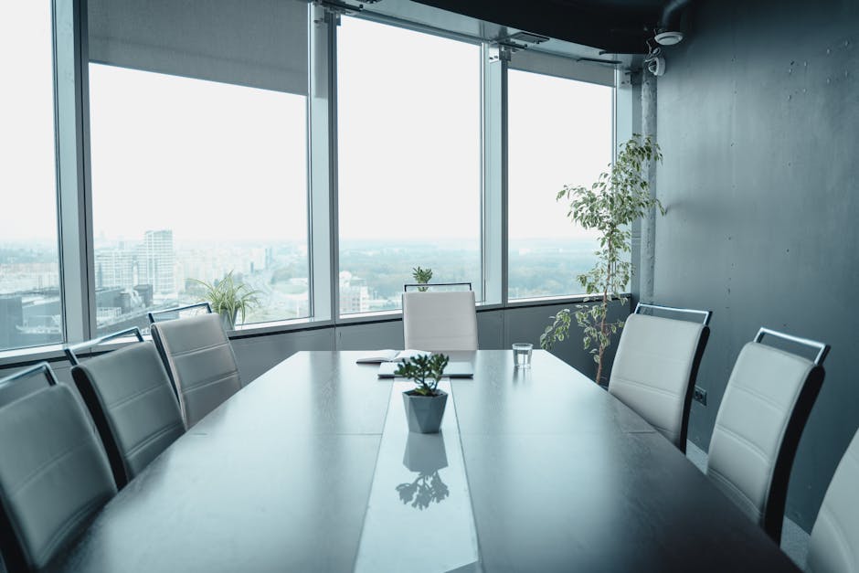 Spacious conference room with panoramic city views and elegant furnishings.